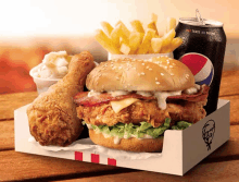 a kfc box contains a chicken sandwich french fries and a can of pepsi