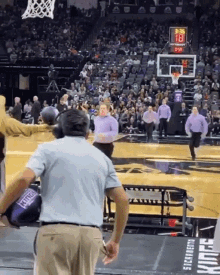 a basketball game is being played in front of a crowd and a scoreboard that shows the score at 3:36