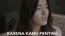 a woman 's face is shown with the words karena kamu penting below it