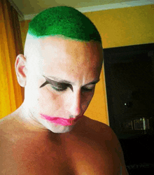 a shirtless man with green hair and a joker face paint