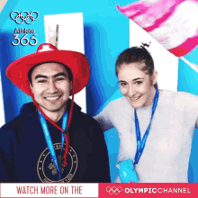 a man wearing a red hat and a woman wearing a medal around their neck are posing for a photo with the olympic channel