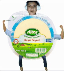 a man wearing headphones is standing in front of a package of sutas cheese