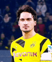 a soccer player wearing a yellow jersey with bvb on the front