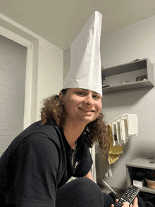 a man with long curly hair wearing a paper bag on his head