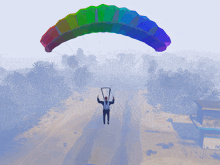 a man is flying in the air with a rainbow parachute