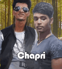 a man wearing sunglasses and a shirt that says chapri stands next to another man