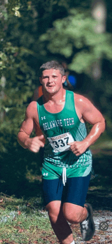 a man wearing a delaware tech shirt is running