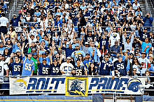 a large crowd of people watching a football game with a banner that says rolt pride