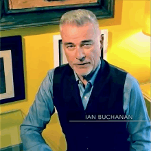 a man in a vest with the name ian buchanan on the bottom