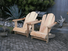 a pair of wooden adirondack chairs sit on a patio