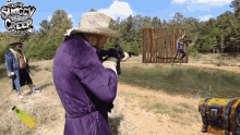 a man in a purple robe is holding a gun in front of a sign that says the shaggy and the creepy show