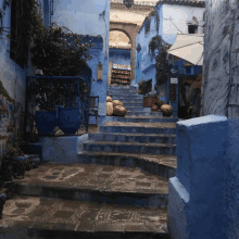 a narrow alleyway with stairs leading up to a building with a sign that says ' a ' on it