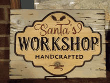 a sign that says santa 's workshop handcrafted on it