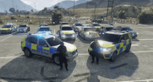 a group of police cars are parked in a parking lot with officers standing in front of them