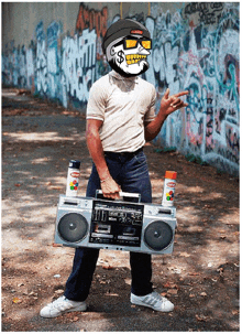 a man is holding a boombox with spray paint on it