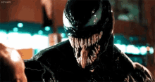 a close up of venom 's face with a huge mouth and teeth .