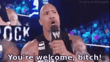 a wrestler is holding a microphone and saying " you 're welcome bitch "