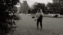 a black and white photo of a man carrying a child with the words " and my story just beginning " on the bottom