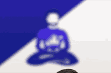 a blurry picture of a person sitting in a lotus position on a blue and white background