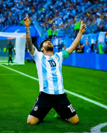 a soccer player wearing a number 10 jersey is kneeling on the field