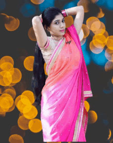 a woman in a pink saree with the word egr on the bottom