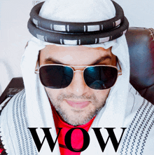 a man wearing sunglasses and a keffiyeh with the word wow written on the bottom