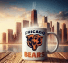 a chicago bears coffee mug is sitting on a wooden table with a city skyline in the background .