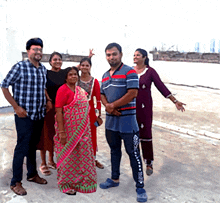 a group of people posing for a picture with one wearing a shirt that says ' adidas ' on it