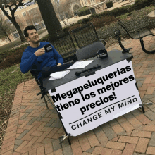 a man sitting at a table with a sign that says mega peluqueria tiene los mejores precios