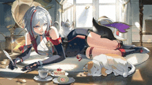 a girl is laying on the floor with two cats and a cup of tea