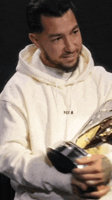 a man wearing a white hoodie with msgm on it