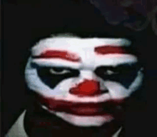 a close up of a person 's face with a clown mask on .