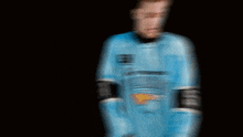 a blurry picture of a person wearing a blue jersey that says ' miami dolphins ' on it