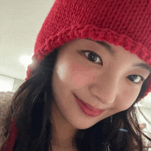 a close up of a woman wearing a red hat