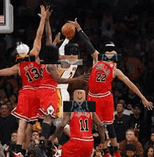 a group of basketball players are playing a game of basketball and one of the players has a lego head on his jersey .