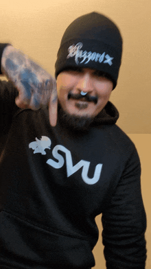 a man wearing a black hoodie that says " svu " on it