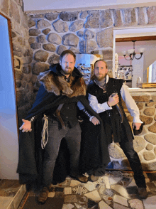 two men in medieval costumes pose for a picture