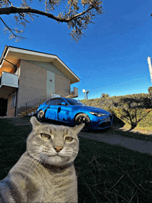 a blue car is parked in front of a brick building