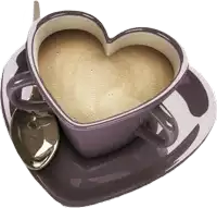 a cup of coffee in the shape of a heart with a spoon .