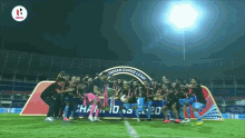 a group of soccer players are posing for a picture in front of a sign that says indian super league