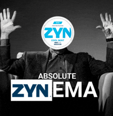 a man in a suit sits in a chair with his hands in the air behind a zyn absolute zyn ema logo