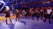 a group of people dancing on a stage with the words danse stars on the bottom