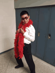 a young man wearing sunglasses and a red boa