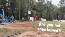 a man in a red shirt is running on a dirt field with the words " are you not entertained " below him