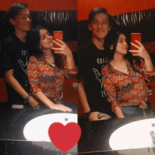 a couple taking a selfie in a bathroom with a red heart in the middle