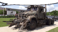 a transformers truck is parked in front of a building .