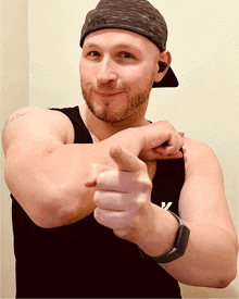 a man wearing a black tank top and a hat that says russell