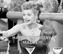 a black and white photo of a woman sitting at a table with martini glasses and a happy birthday message .