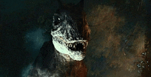 a close up of a dinosaur with its mouth open in a cave .