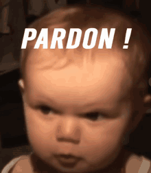 a baby has the word pardon written on his forehead